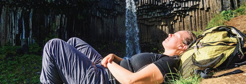 Book Early & Save — More Availability, Lower Prices Sunrise over Icelandic mountains with a white campervan on a quiet road, illustrating savings and wider availability when you book early.